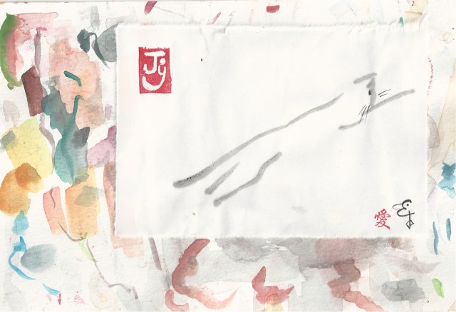 cat leaping on blotter