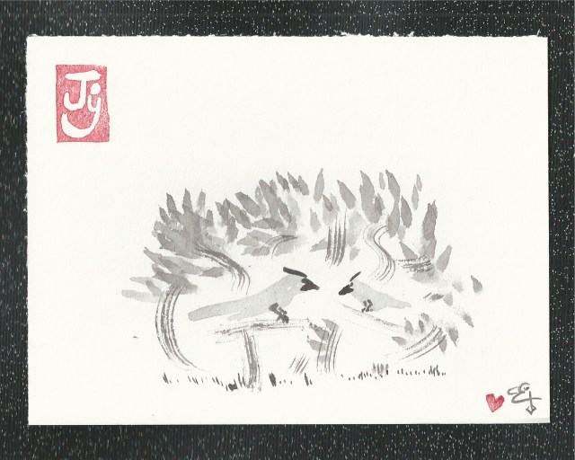 two cardinals in a bush