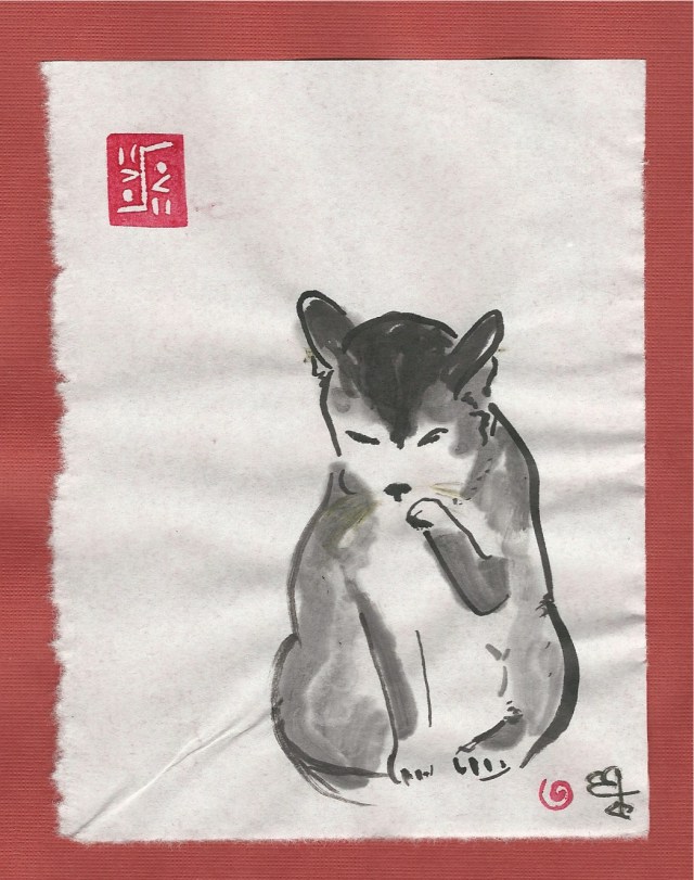 calico-cat-washing-paw